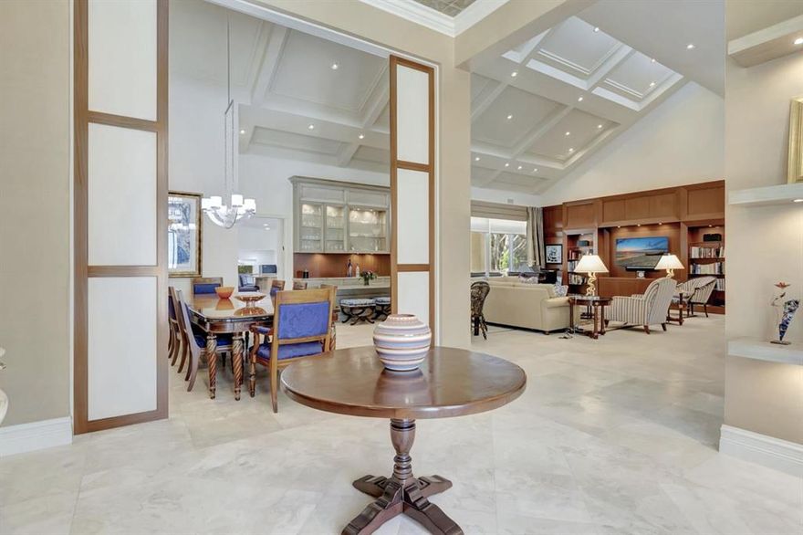 Rarely available expanded estate in Oakbrook. Bright, open beautiful home is 5259 sq ft, 4 beds, 4.5 baths, 4-car garage + golf cart area. Enter this grand home through the custom stainless steel French glass doors into the souring foyer to the beautiful, paneled dining room, large bar area and vaulted ceiling living room. Right off the foyer is a large powder room and built in library and office. The neutral finishes work well with all pallets. Wood kitchen cabinets, wolf appliances, and subzero refrigerator as well as the new glass tile backsplash, stone counter tops finish off the entertaining spaces. Marble floors through the main floor space, wood-built ins in the living room and paneled office are found throughout. This home is complete with solar powered panels, and generator