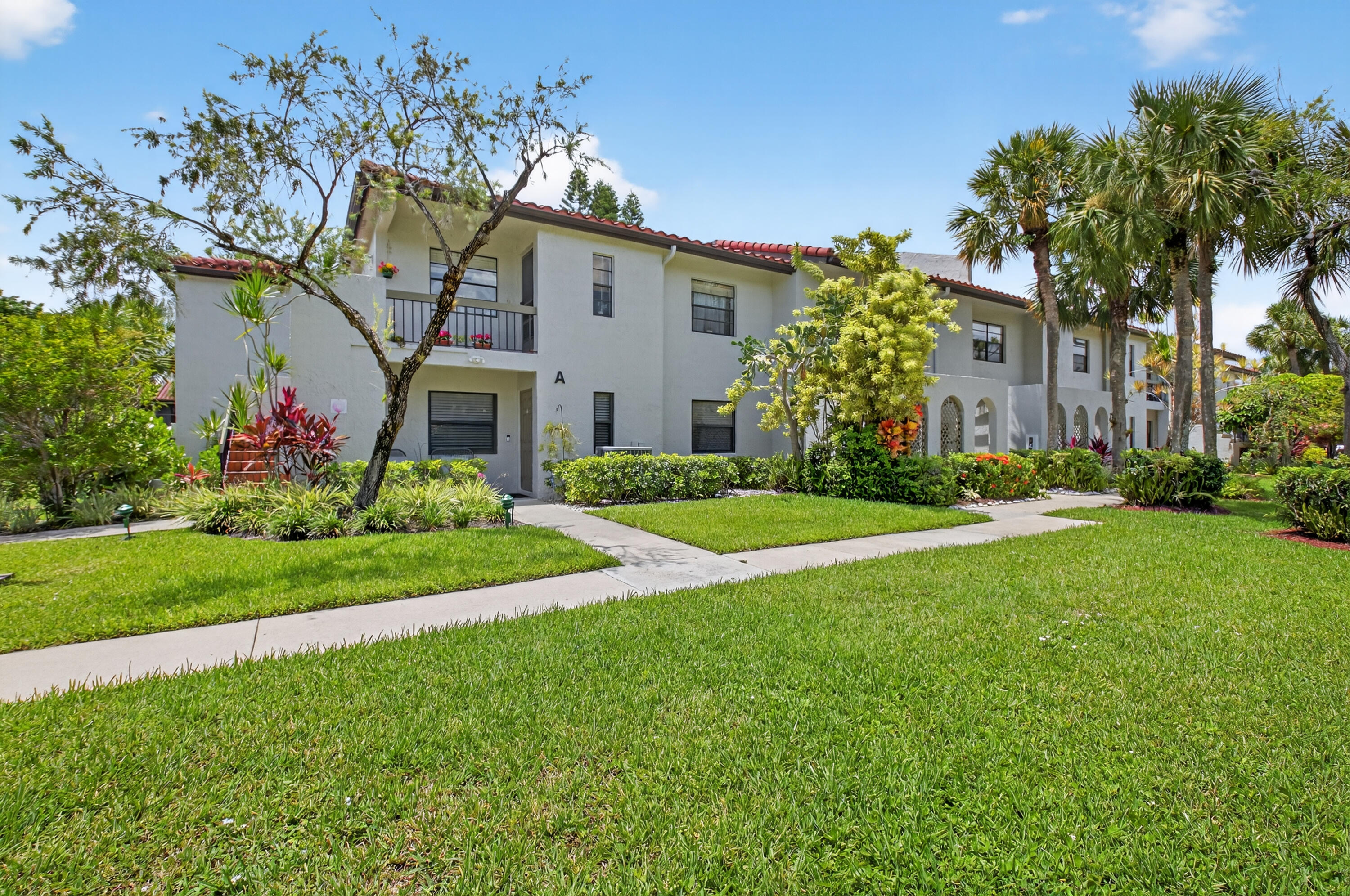 A picture says 1000 words. Elegantly renovated end unit with impact glass throughout. Updated kitchen, baths, woodwork, and move-in ready. This bright 1st floor condo, with ideal exposure and view, is ready for you to enjoy. Super quiet location within the community, yet close to all shopping and dining needs. Membership in Boca Lago Country Club is NOT mandatory.