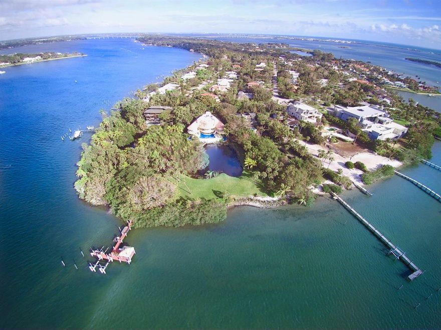 Located at the southern tip of Sewall's Point this 2.5 acre lot with 345 feet of water frontage is truly a tropical paradise. Uniquely designed with all the main living spaces overlooking a spectacular freeform pool, River, and lush landscaping, plus your own spa room with sauna as well as private balconies and elevator to roof terrace with spectacular almost endless views. Built to withstand natures forces with poured concrete flooring and pilings to create a true fortress with three levels. From the pool and patio the property extends itself with an inland lake and walking bridge that meanders to the dock with boat lift.