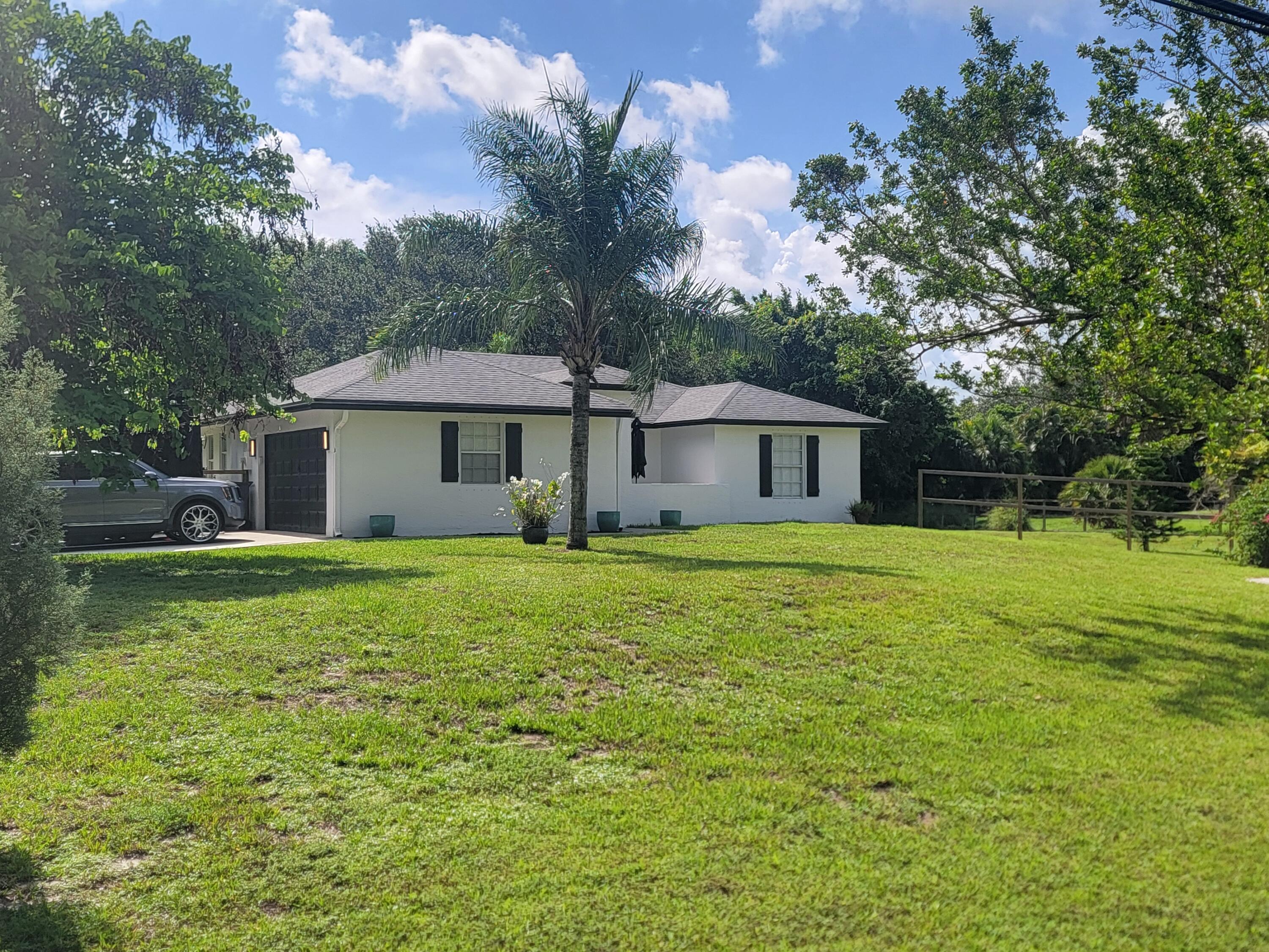 Check out this beautifully updated 3 Bedroom 2 bath 2 car garage home situated on 1.3 acres in Palm Beach Country Estates. AC was done in 2023Roof in 2019Septic system was cleaned and lines replaced in 2023 whole house water filter installed in 2022. The house was built with Royal wall construction. Which is solid poured insulated concrete panels.