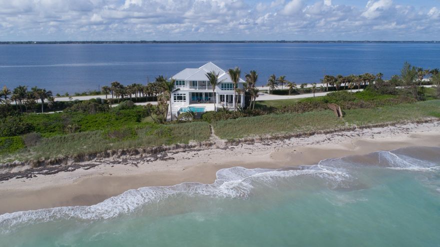 With the ocean as the main attraction, you'll be mesmerized by the irresistible views, as well as unobstructed river views. The interior's design pallet is like an extension of the beach, creating a peaceful aesthetic. High end finishes & rich millwork punctuate the superb craftsmanship and structural integrity. Dream kitchen offers a 6-burner gas cooktop, 2 full-size refrigerators and built-in coffee station. Entertain in the Pub room, the perfect spot to watch TV with the convenience of a full bar. The luxurious master suite has a morning kitchen just outside in the hall. Enjoy the outdoor kitchen, covered lounging areas and infinity edge pool. The garage can accommodate 6+ vehicles and there's plenty of storage throughout the home. This is Coastal Living at its finest!