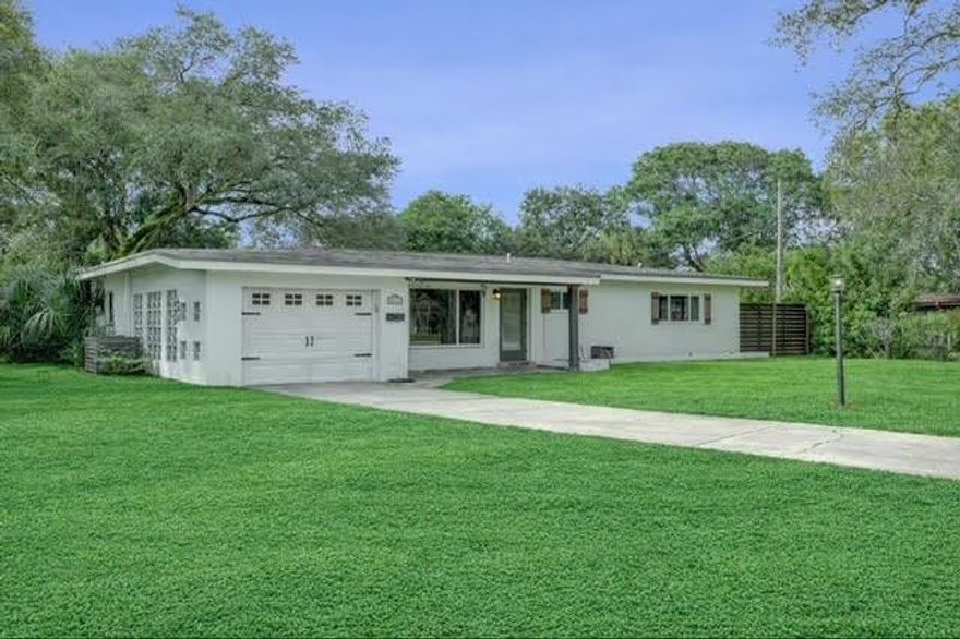 Your EXPANSIVE CORNER LOT thoughtfully designed 3-bedroom, 2.5-bath home offers privacy, space, and effortless living. Terrazzo floors flow throughout the split floor plan, with impact windows, a tankless water heater, interior laundry, and an attached one-car garage. Enjoy lush landscaping, mature trees, a screened porch, and a fully fenced yard in your outdoor oasis. A detached workshop with a half bath is ideal for hobbies, extra storage, or a private workspace. This property features two driveways providing ample parking with room for an RV or boat. A public boat ramp with ocean access is just one mile away. Property is close to downtown FLL, FLL Airport, and major highways. With this ideal location and room for a pool this is rare find won’t last!