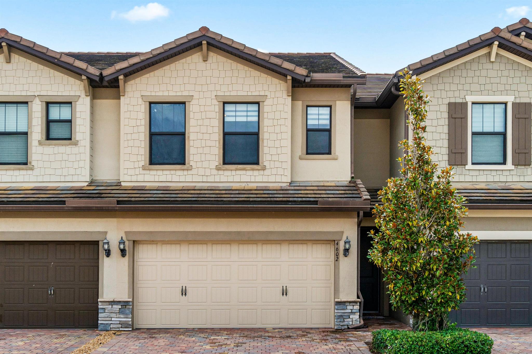 Step into this impeccable 2018-built townhome where refined design meets modern comfort. This stunning 3-bedroom, 2.5-bath residence boasts a gourmet kitchen featuring stainless steel appliances, granite countertops, and an oversized center island perfect for entertaining. The open-concept floor plan flows effortlessly from the inviting living and dining areas to a private patio overlooking lush landscaping, creating an ideal space for both relaxation and gatherings. Upstairs, the spacious primary suite offers a large walk-in closet and a luxurious en-suite bathroom with dual vanities, while two additional bedrooms provide ample space for family, guests, or a sophisticated home office.