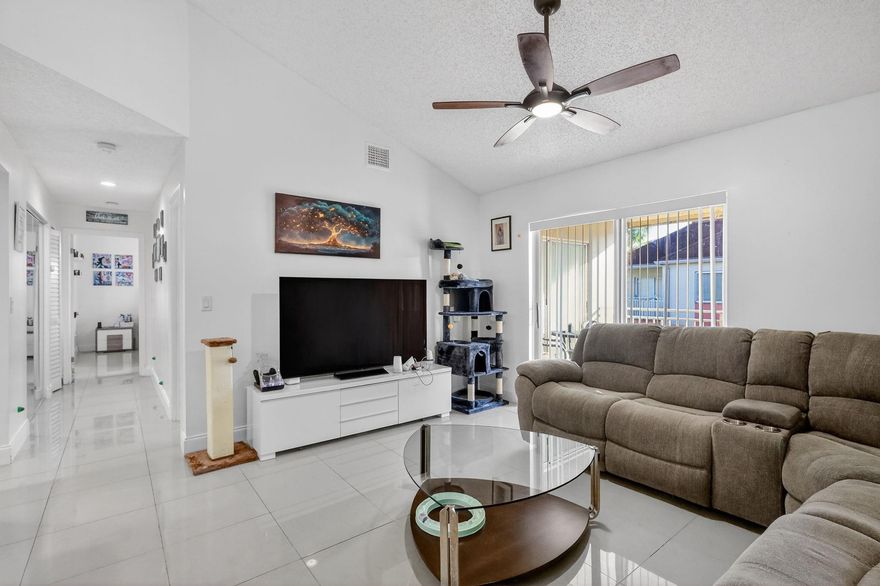 Discover this immaculately move-in-ready top-floor residence, perfectly situated within the highly sought-after, gated community of Via Rustica in Hialeah. Features a desirable split 2-bedroom, 2-bathroom layout, providing optimal privacy. Experience an immediate sense of space and light, enhanced by vaulted ceilings that soar above the main living areas, complementing the bright, open-concept floor plan. Enjoy peace of mind and exclusivity within the gated Via Rustica community—one assigned parking spot for the owner, supplemented by ample visitor parking for guests. Prime location, just moments away from top-tier shopping centers, diverse dining options, excellent schools, and major transportation corridors, ensuring an easy commute and accessible daily living. No rental restrictions
