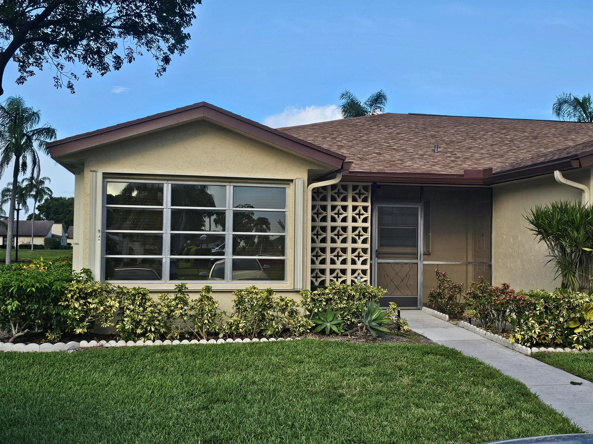 Age 55 plus community well located just north of Atlantic Blvd. Completely remodeled spacious and bright 2/2 corner villa on the lake. Open kitchen w/black marbled granite counters. 42 wood 'soft close' cabinets w/pantry, double stainless steel sink, garbage disposal and newer appliances. Living room has fan w/ ceiling light.Sony 55' wall mounted TV w sound bars/bluetooth capabilities and bass speaker, Great BR has ceiling fan w/light.TV wall mount, Master BR has ceiling fans/light,Sony 50' wall mounted TV all closets have melamine wood shelving. Master BR has shower/tub combo/vent and heat lamp, Guest has a 'no step in' walk in shower/vent and heat lamp, Neutral wood like ceramic flooring throughout, stack washer/dryer inside. Alarm system, accordion shutters & blinds on every window.