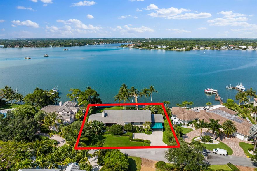 Looking for the 'best of the best'? You found it! Enjoy wide, blue water views from every angle of this riverfront home in prestigious Bay Harbor, an exclusive, highly sought-after community of just 15 estate homes. The spacious floor plan includes 5 bedrooms, 5 full baths & 2 half baths. The view from the master balcony is the best you'll find! The .42 acre home site offers 150 ft. of water frontage, is equipped with a spacious, private dock, and 3 boat lifts. The roomy rear yard features an expansive covered lanai, oversized, resort-style pool, and a covered summer kitchen & bar. A boater's paradise, it's just a paddle board ride away from Jupiter's sandbar, a short boat ride to Jupiter's finest restaurants & bars, minutes to the ocean, and only a couple of hours by boat to the Bahamas