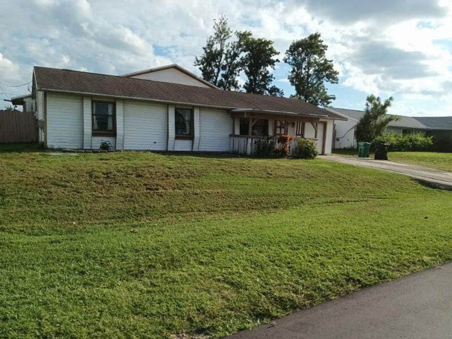 Great Opportunity To Make This 3 Bedroom, 2 Bathroom, 1 Car Garage Home Your Own! This Port St. Lucie Property Offers A Solid Layout With Plenty Of Potential For Personal Touches. Perfect For First-Time Buyers Or Anyone Looking For A Home They Can Customize To Fit Their Style. Enjoy A Huge Master Bedroom with Walk In Closet and En Suite Bathroom, Spacious Fenced Yard, Convenient Location Near Schools, Parks, Shopping, And Easy Access To Major Roadways. This Could Be The Perfect Place To Call Home. New Washer & Dryer, Roof 2020, AC 2020 & HWH 2022. Bring Your Ideas And Make It Shine!