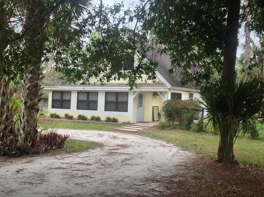 Storybook chalet nestled among the oaks, pines and cabbage palms on secluded 1.25 acres! Located on the sought after north end of Jupiter Farms,  you are right at the Culpepper property as well as endless horse trails for riding! Two entrys into the rustic wood roofed florida room, slate tile in living areas with open kitchen, soaring ceilings and lots of natural light! Kitchen features a gas range, lovely center aisle breakfast bar, stack washer and dryer in utility closet. Guest room with patio and sliders to backyard.   2nd bedroom has new carpet, the master loft area features new bathroom &  carpet..  Whole house recently painted, ready to  move in! Separate fenced dog area, room for pool or barn! Gorgeous blue palmettos and landscaping, best lot around! Special ambiance, dont miss it!