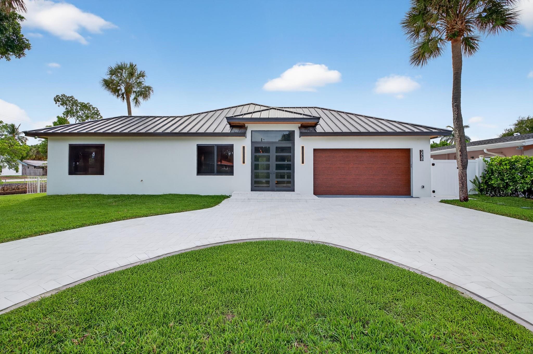 Modern new construction single family home in Oakland Park's Coral Terrace offering 160 ft of waterfront with breathtaking canal views. This sleek 3-bedroom, 2.5 bathroom residence showcases high-end finishes, with porcelain oversized tiles throughout, a chef’s kitchen with luxury appliances, and an open layout designed for indoor-outdoor living. The backyard features a brand-new pool with white marble pavers and stunning water views.
