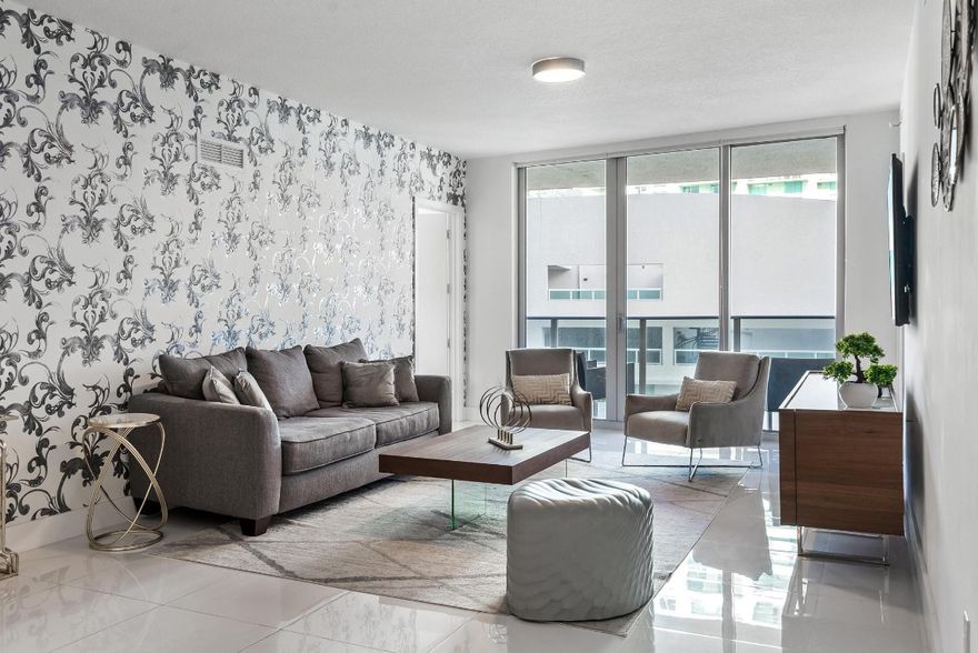 Discover this stunning 2-bed, 3-bath (+ versatile den) luxury condo on the 35th floor of Aria On The Bay with breathtaking Biscayne Bay views and convenient elevator access directly to your unit. Tile flooring throughout, and modern updates include white quartz counters and sleek cabinetry that flow seamlessly in the kitchen and bathrooms. Light-filled, and spacious, this residence offers a perfect blend of style and comfort. Ideal for those looking for luxury and lifestyle, as this building offers it all. Resort style amenities include sunrise & sunset pools, hot-tub, sundeck, luxurious spa, private theatre, 24 hour concierge service, business center, residents lounge, fitness center, teen lounge & kids room, valet and security. Steps away from Downtown Miami, Midtown and more.