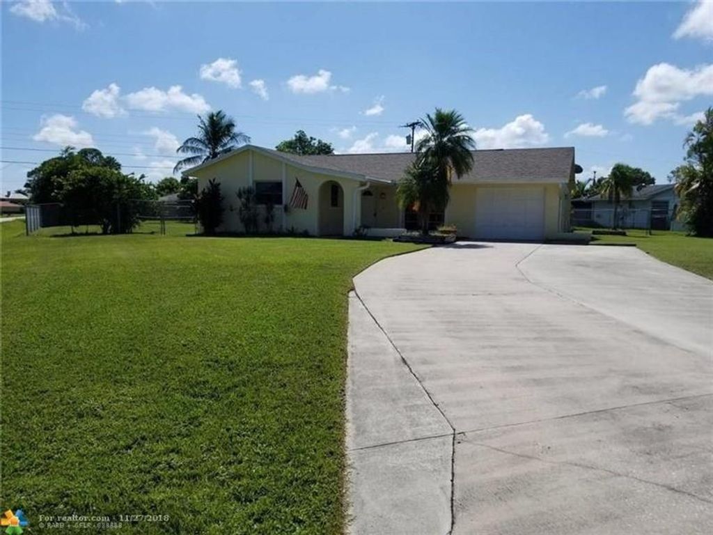 Photo of 390 SE Tranquilla Ave, Port Saint Lucie, FL 34983 (MLS # F10305410)