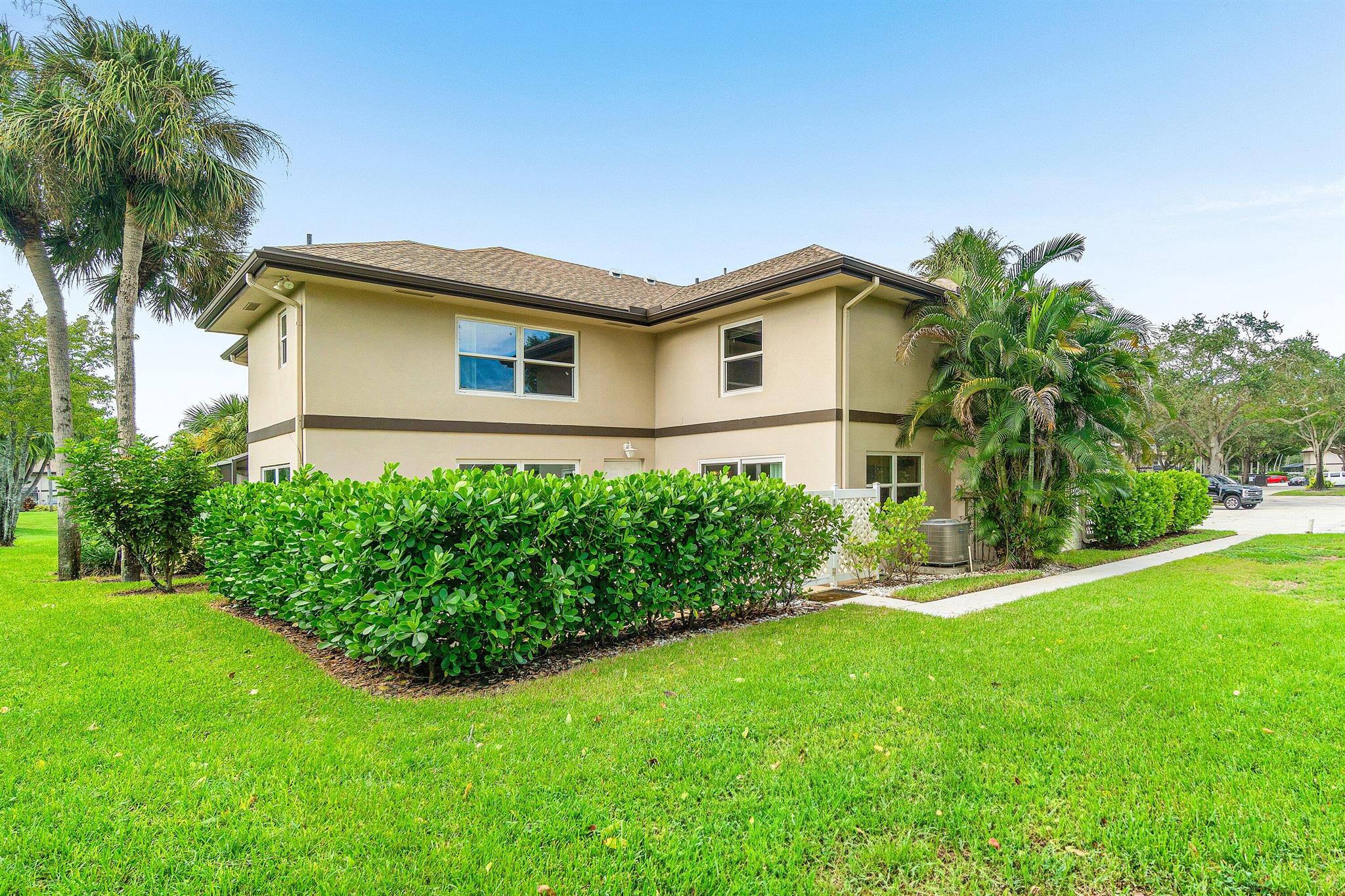 Picture yourself in this charming two-story townhouse  in fabulous Royal Palm Beach. Tastefully updated 2 bedroom/ 2 and 1 1/2 bath, Impact Windows, spacious closets in each bedroom. A Private fenced-in patio. Full size washer and dryer. Bright and light townhome. Community amenities include a lovely pool. Two assigned parking spaces, Beautifully manicured parklike grounds throughout the neighborhood. Ready to move in. Close to shopping,  a short drive to the lively downtown area and pristine beach!