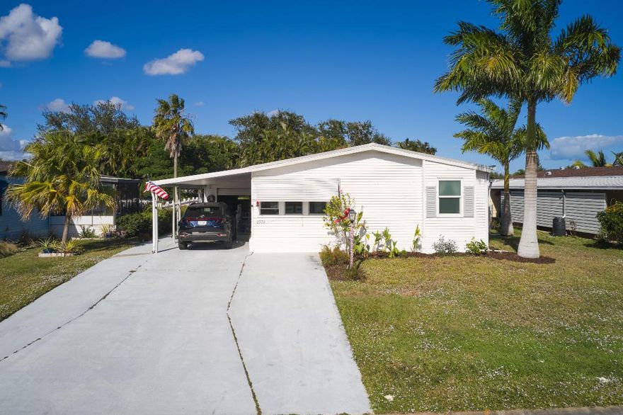 Move in ready home in the active 55+ community of St. Lucie Falls. You own the land & low HOA fees that include cable and internet. The community offers many amenities: 2 pools, 2 clubhouses, tennis/pickleball, fitness center, billiards, ping pong, shuffleboard, bocce ball, and daily activities. This 3 bed, 2 bath home is conveniently located to the clubhouse and all amenities. Some of the many features of this home include: newer metal roof (2018), hurricane impact windows throughout, updated kitchen and bathroom, 2024 water heater, new underlining and skirting, 1 car garage/workshop, all-weather Florida room, reinforced carport, 2018 AC, plus much more. Schedule your private viewing today.