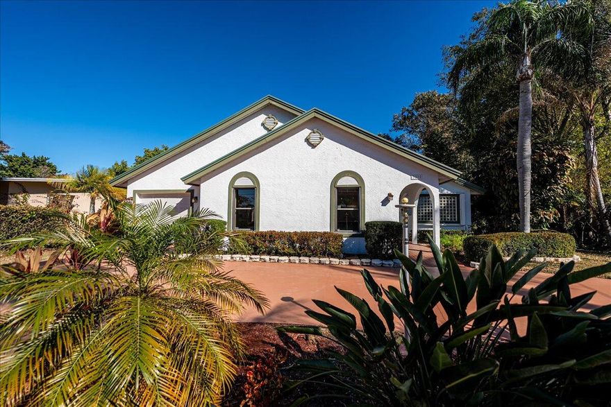 Charming 3-bedroom, 2-bath single-family home is in the desirable Sandpiper Bay Community, offering comfortable Florida living. The bright, open layout offers abundant natural light flowing through large windows and French doors. A master suite features a dual-sink vanity and walk-in closets. All counters throughout the home are beautiful Corian for a sleek, low-maintenance finish.  
Step into your private backyard paradise: a spacious screened lanai showcasing a swim spa/hot tub combination with a Wi-Fi connection surrounded by lush tropical foliage. Beyond the lanai, enjoy a generously sized paver patio with a powered tiki hut. 
Highlights: attached 1-car garage, dedicated laundry room, natural gas pool/spa heater & hot water, and garden shed.
A move-in-ready Paradise. The home is nestled in the desirable Sandpiper Bay Community in Port St. Lucie, FL, renowned for its resort-style lifestyle, well-maintained greenspaces, and convenient location near the St. Lucie River, botanical gardens, and vibrant local amenities. This peaceful enclave offers residents access to a wealth of community perks, golf course facilities (historically part of the area's legacy), and scenic trails, creating an ideal blend of relaxation, fitness, and social opportunities just minutes from beaches, shopping, dining, breweries, I-95, and the Turnpike.
Inside, the bright, open layout delivers comfortable, light-filled living with abundant natural light pouring through large windows adorned with elegant plantation shutters for privacy and timeless style. The luxurious master suite features a dual-sink vanity, bidet, and generous storage with two walk-in closets. The updated guest bathroom includes modern fixtures and a refreshed design for added comfort and convenience. A standout guest bedroom comes equipped with a Murphy bed, providing flexible space for visitors while maximizing room functionality for everyday use or a home office. All counters throughout the home are premium Corian, sleek, durable, low-maintenance, and resistant to stains and scratches. Practical features abound: an attached 1-car garage, a dedicated indoor laundry room with extra cabinetry, a natural gas tankless hot water & Pool/spa heater, a garden shed,  and thoughtful touches throughout.
A true highlight is the expansive outdoor paradise, starting with a spacious screened lanai that showcases a swim spa/hot tub combination with new pumps (see document) and Wi-Fi connection for jets, heat, and lights. A swim spa is a versatile hybrid of a hot tub and endless pool: it's a compact, jetted vessel (longer and narrower than a standard spa) that generates a powerful adjustable current, allowing you to swim in place for exercise, lap-style swimming, or low-impact aquatic workouts year-round while also offering soothing hydrotherapy jets and heated seating for pure relaxation, family fun, or recovery. It's perfect for fitness enthusiasts or anyone seeking pool-like enjoyment without the space or maintenance of a full pool.
Complementing the lanai is a serene koi pond (disconnected) encircled by lush tropical foliage, mature palms, and vibrant greenery for a tranquil, zen-like ambiance. Beyond lies a generously sized paver patio which borders the Santa Lucia River Club golf course, featuring an electric-powered tiki hut ideal for alfresco dining, evening gatherings under the stars, or quiet unwinding in your personal resort-style retreat.
Additional exterior conveniences include a welcoming circle drive for easy guest parking and access, plus exterior RV electric and waste hookups perfect for accommodating recreational vehicles, boat trailers, or extended family visits without hassle.
This move-in-ready gem masterfully blends cozy indoor comfort, thoughtful updates, and exceptional outdoor amenities into a true tropical haven. It's an opportunity to embrace effortless Florida living.
Furnishings do not convey home.