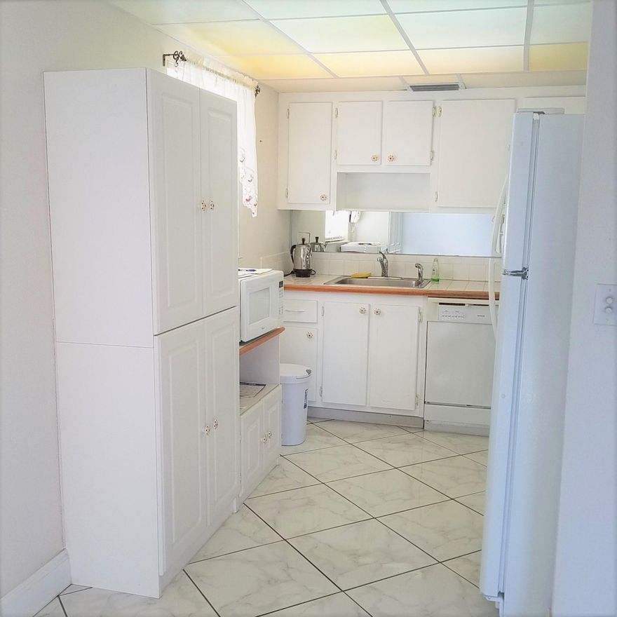 SELLER WANTS OFFERS! True corner end unit! Don't do steps? There is a lift. Convenient 2nd floor location with plenty of guest parking. Updated kitchen & baths. Newer AC. Tile on the diagonal in Entry, Dining, Kitchen & Living Room Hallway to beds & baths. Carpet in Bedrooms. Tons of storage space: walk-in-master closet, floor to ceiling closet along one wall of the 2nd bedroom PLUS storage area on the covered screened balcony, too.  Full size clothes washer & dryer convey.  Not 55 yet?  No problem: Buy now to rent out until you're ready to use it! Pets are restricted to 'bonafide' service animals & must be approved by the Assn.  Easy to show; quick close available, too.  Avoid disappointment, call now for an appointment.