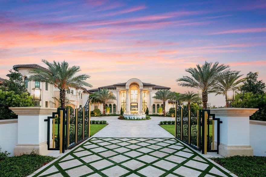 One of South Florida's most prestigious residential communities provides the exclusive setting for an expansive (and brand new) compound that astonishes at every turn. Cast amid 2.5 acres in Stone Creek Ranch, the nationally renowned enclave in west Delray Beach comprised of only 36 multimillion-dollar lots, this sprawling eight-bedroom layout (with eleven full baths and four half baths) encompasses nearly 18,500 square feet of living space—and some 27,000 square feet overall. A grand courtyard driveway beyond the gated entrance, featuring a cascading water fountain, sets the tone for all that's to come. The embrace of towering palms and lush, impeccably manicured foliage further heightens the exterior splendor throughout the recently completed lakefront property. As does a championship tennis court (that doubles as a full basketball court), an infinity-edge pool with whirlpool spa, and a separate pool cabana. The drama continues inside this transitional estate with spacious living and entertaining areas, artisanal lighting and design details, and luxury comforts including a fitness/spa area with a sauna and massage room. Additional amenities include a cinema-style theater with state-of-the-art acoustics; a game room; offices both upstairs and downstairs; elevator access and catering kitchen, brimming with the latest high-tech appliances and functional, yet inspired transitional design. The master suite features stunning his/her baths, oversized his/her walk-in closets, and a sitting area. In addition to a second driveway, the property includes a trio of three-car garages, one with a lift option that gives homeowners the potential to house 12 vehicles.