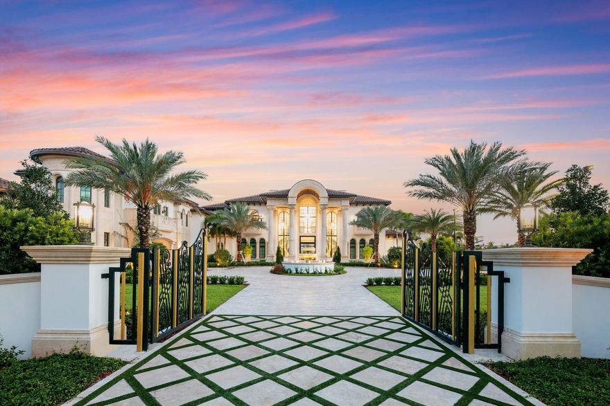 One of South Florida's most prestigious residential communities provides the exclusive setting for an expansive (and brand new) compound that astonishes at every turn. Cast amid 2.5 acres in Stone Creek Ranch, the nationally renowned enclave in west Delray Beach comprised of only 36 multimillion-dollar lots, this sprawling eight-bedroom layout (with eleven full baths and four half baths) encompasses nearly 18,500 square feet of living space—and some 27,000 square feet overall. A grand courtyard driveway beyond the gated entrance, featuring a cascading water fountain, sets the tone for all that's to come. The embrace of towering palms and lush, impeccably manicured foliage further heightens the exterior splendor throughout the recently completed lakefront property. As does a championship tennis court (that doubles as a full basketball court), an infinity-edge pool with whirlpool spa, and a separate pool cabana. The drama continues inside this transitional estate with spacious living and entertaining areas, artisanal lighting and design details, and luxury comforts including a fitness/spa area with a sauna and massage room. Additional amenities include a cinema-style theater with state-of-the-art acoustics; a game room; offices both upstairs and downstairs; elevator access and catering kitchen, brimming with the latest high-tech appliances and functional, yet inspired transitional design. The master suite features stunning his/her baths, oversized his/her walk-in closets, and a sitting area. In addition to a second driveway, the property includes a trio of three-car garages, one with a lift option that gives homeowners the potential to house 12 vehicles.