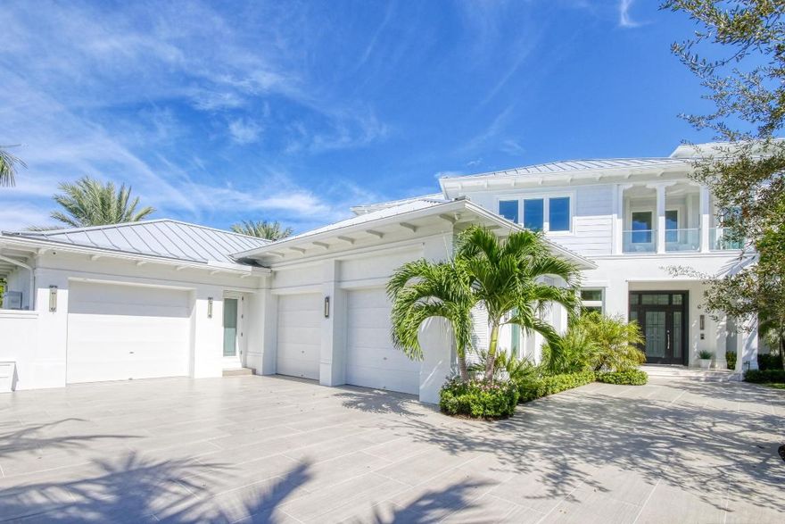 Live in the Golden Harbour where easy access to RPYCC, Downtown Mizner, the Intracoastal Waterway and the beach make this a prime location. This 2017 custom home on a raised point lot w/no back neighbors, provides gorgeous unobstructed water views,  210' of dock space, boat & jet ski lift, salt water pool w/ jetted tub and sun shelf, natural gas fire pit & full house, generator. The interior is pure elegance. Incredible details include wood floors throughout, custom fireplace, elevator, expansive kitchen & island, pocket sliding doors to bring the outdoors in PLUS Control 4 system to navigate all your lighting, music & security. The grande master suite with a private balcony, stunning gas fireplace, 2 walk-in closets & private flex space will impress the most discriminant home buyer. Theres still more...Butlers pantry, walk-in pantry, 2 dishwashers, laundry rooms on both levels with sinks, a/c storage in garage, 20,000 lb boat lift, double jet ski lift, cul-de-sac lot, the 3 car garage could have lifts added for the car enthusiast.
Pool has artistic lighting and fountains, (but designed for the swimmer as well) Generous outdoor landscape and walkway lighting plus astro turf for easy maintenance.The U shaped natural gas fireplace allows for large gatherings for those beautiful South Florida evenings, Enjoy this sunny, well appointed, timeless beauty, you will not be disappointed. 

Architects by Randall Stofft 
Builder T & T Home Builders