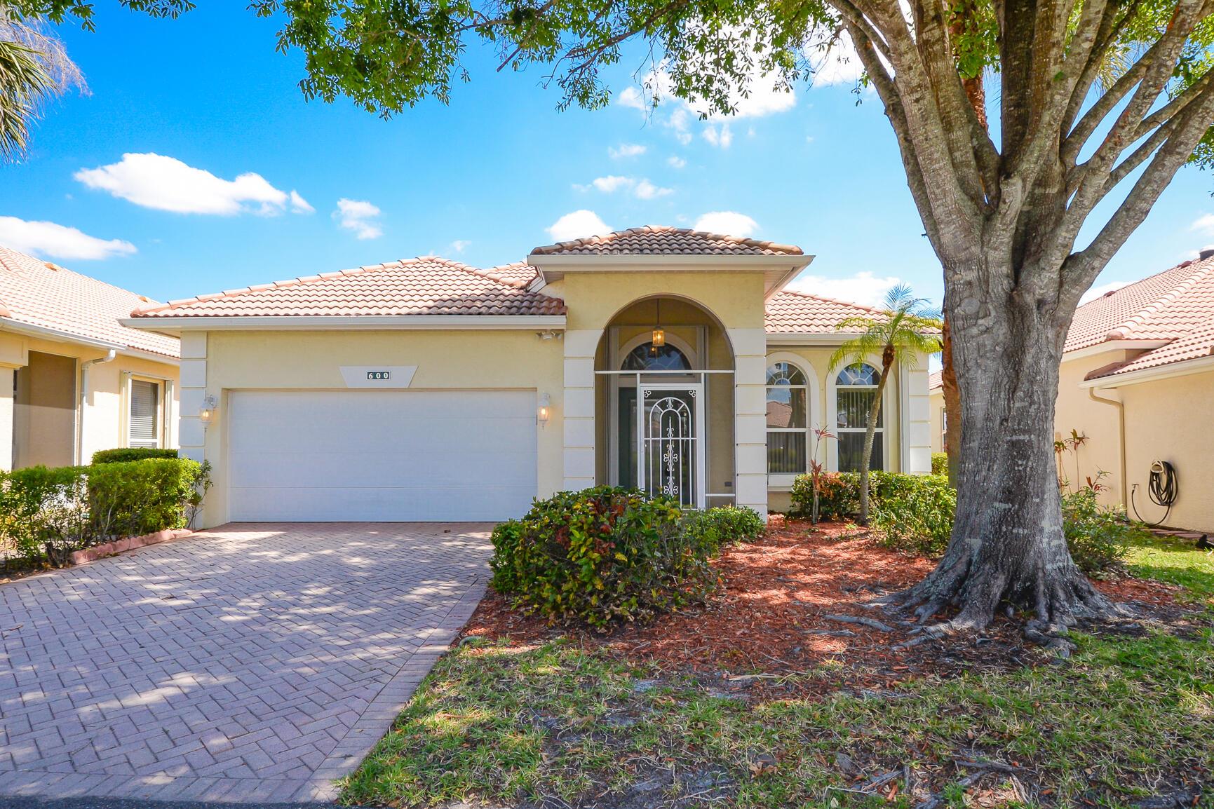 Beautiful Cambridge Model in ''Isle of Capri'' at ''Kings Isle'', fabulous 55+ community in the heart of St Lucie West (A planned Community). Features CBS Construction, Barrel Tile Roof, Decorative Driveway, Covered Patio, freshly painted interior & Move in condition. Hosts 2 Bedroom's, 2 bath's, Den & 2 Car Garage. Spacious Screen enclosed Lanai with beautiful Lake View. Details include Volume Ceilings, Tile & new carpet, open eat in Kitchen with White Cabinets, pantry & NEW Stainless steel appliances. Split Floor Plan, large Master Suite includes walk in closet. Updated A/C - 2023, Accordion shutters, water heater 2017, new electric panel & Laundry room. HOA fee's include Manned gated security, lawn care, cable, internet & The Royal Club offering something for everyone.