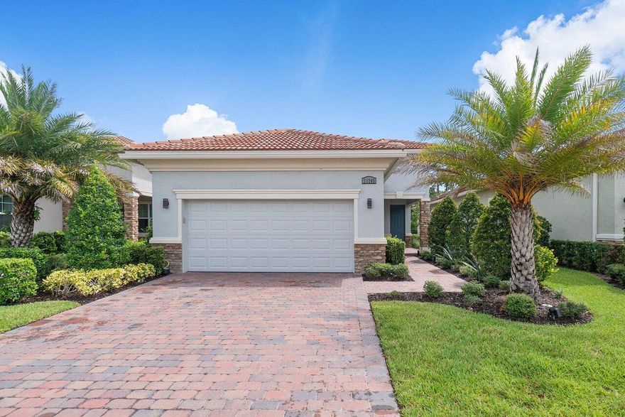 Welcome to your dream home at PGA Verano! This meticulously maintained gem is move-in ready without the hassle of waiting 12 months to build. With it's prime location, this property stands out from the rest with a private backyard and a breathtaking lake view right out front.

Step inside this beautiful home, and you'll find a host of thoughtful upgrades. The kitchen shines with under cabinet lighting and modern Quartz counters. Throughout the home, you'll enjoy soft-close drawers, brushed nickel hardware, and Moen faucets, adding elegance and functionality to every corner.

The primary bedroom boasts not one, but two separate closets for ample storage space. The bathrooms offer privacy windows and full-height shower tiles, creating a spa-like atmosphere. The primary bathroom stands out with frameless shower glass and a luxurious rainhead shower.

Enjoy the convenience of modern living with LED lighting and dimmers installed throughout the home, along with motorized blinds in the master bedroom and den office. You'll also love the screened lanai patio, perfect for relaxing outdoors.

Garage enthusiasts will appreciate the utility sink, GFI golf cart charging outlet, epoxy floors, and wall storage panels for an organized space.

The benefits of living here extend beyond the home itself, as the HOA takes care of essential services, including Cable, Internet, Manned Gate, Security, and Landscaping/Lawn Care. Plus, you'll find yourself immersed in a world-class community that boasts top-notch amenities. PGA Verano is renowned for its 3 Clubhouses, Fitness Center, and Resort Style Pools. For the fitness enthusiasts, there's also an Indoor Pool for laps, 27 Pickle ball Courts, 4 Har-Tru Green Clay Tennis Courts, Bocce Ball, Yoga, and Aerobics Studio. Stay engaged with the community through the Lifestyle Director and Activities Teams, who ensure there's always something exciting happening.

Not only does this home have it all, but it also benefits from its proximity to Tradition, where you can enjoy a variety of restaurants, shopping, events, and concerts. Additionally, the location offers easy access to 95 and Turnpike, and the beach is just a short 30-minute drive away.

Don't miss this opportunity to own a piece of paradise in PGA Verano. With its stunning exterior stone elevation and numerous upgrades, this home won't last long. Schedule a viewing now and make this your forever home.