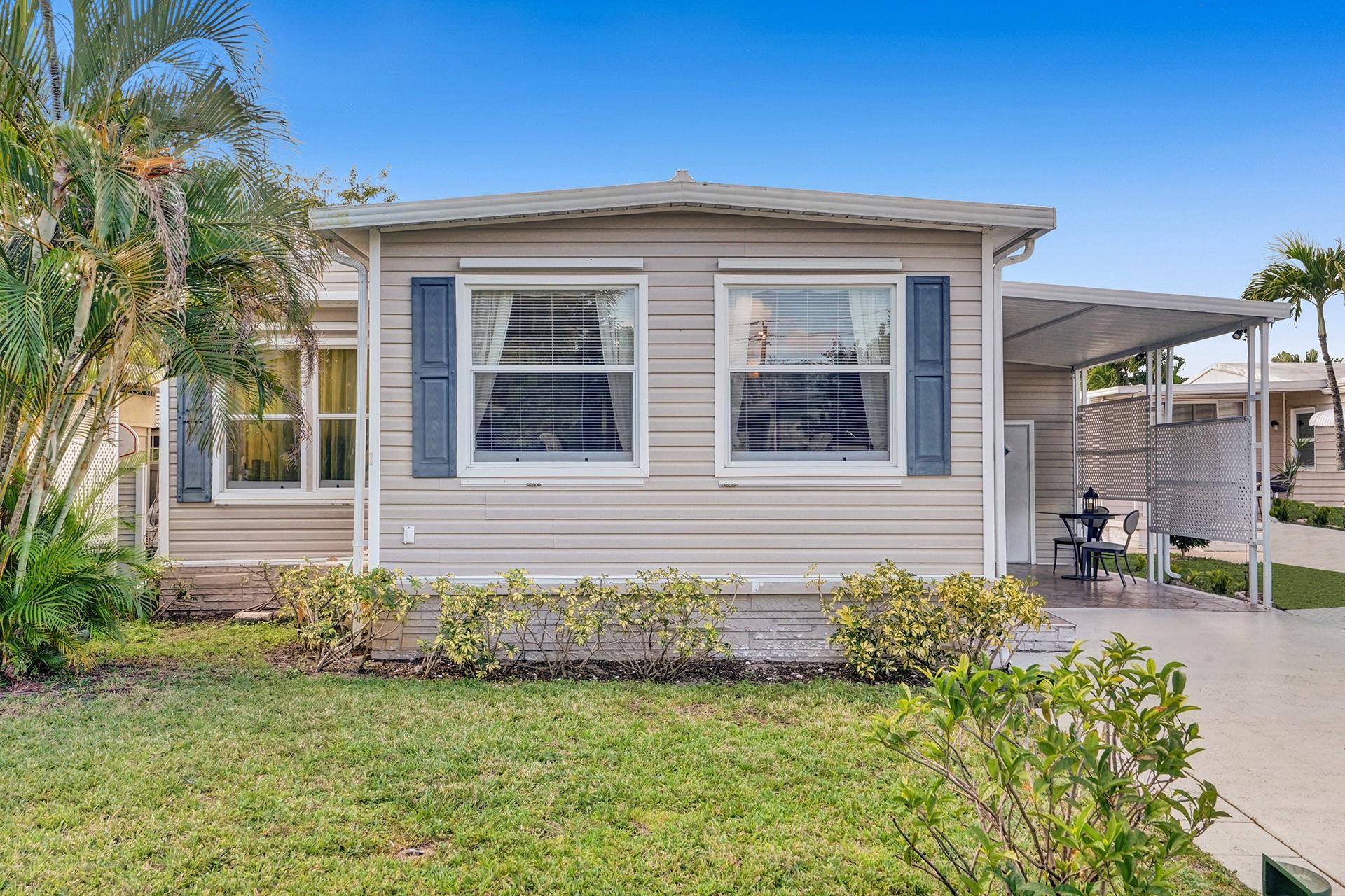 Absolutely beautiful double wide manufactured home in 55+ Park City Estates where YOU OWN THE LAND! Enjoy this lovely 2 bedroom 2 bathroom home with large carport, double driveway and front porch to enjoy the Florida weather. Lots windows bring tons of natural light into this home, and includes other upgrades such as beautiful tile and wood flooring, updated bathrooms, modern kitchen with kitchen island, large carport, shed, newer washer and dryer, and new driveway. House can be sold all furnished. Come see this beautiful home today, and make this home your very own.