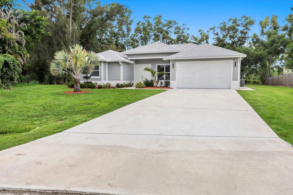 Photo of 419 SW Namoit Place, Port Saint Lucie, FL 34953 (MLS # B26079090)