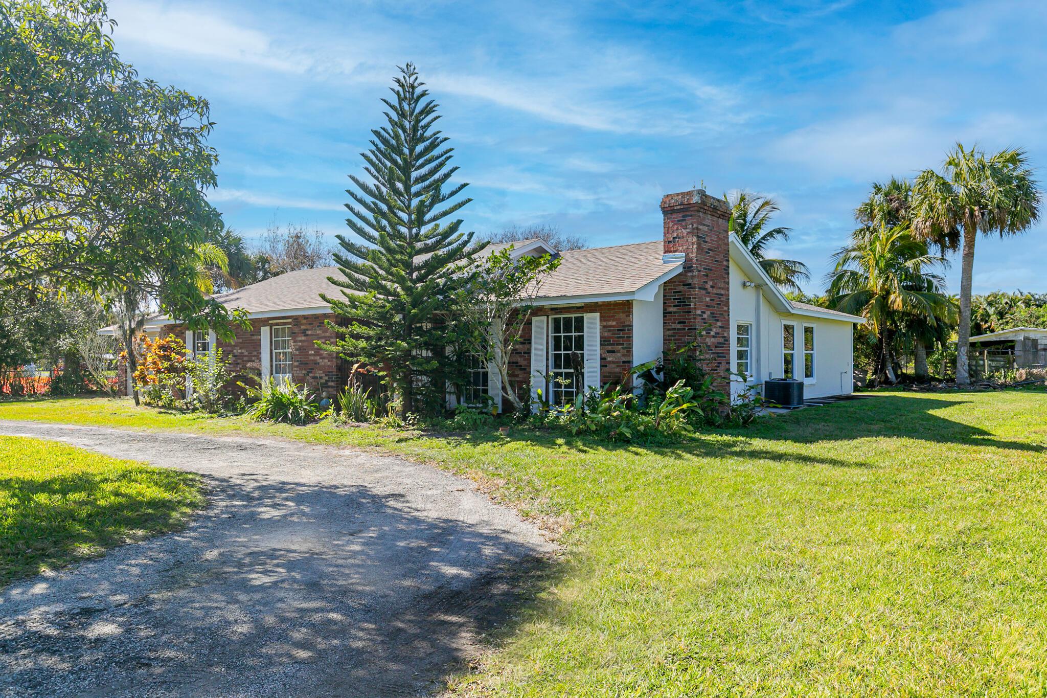 Old Florida charm, a rare find, tucked away with private oasis on over 2 acres of land. with free standing 2300 sq ft barn, centrally located in sprawling area of Fort Pierce, Country living, at its best, in this charming CBS/brick home featuring, brand new roof, 5 large bedrooms, with new LVP flooring 3.5 bath with tiled living areas in formal dining & living, and large family room & extra oversized Florida room. Quaint kitchen with breakfast nook and pass through & full view of family room, brick fireplace for cold cozy nights. This home is perfect to park all your toys, or convert the barn into a large workshop, property completely fenced. Imagine the possibilities, large private family home, or versatile use, daycare, assisted living, or agricultural with rezoning options.