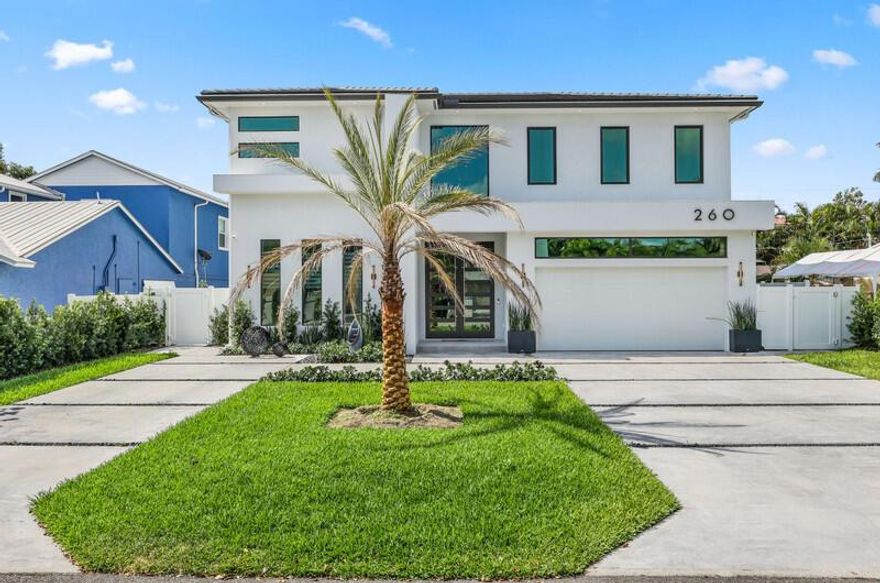 Ultra-Modern East Boca Raton Masterpiece - Steps to the Beach an steps from Mizner! This was built in 2022, designer two-story home delivers modern luxury just minutes from Boca's boutique shops, fine dining, & A-rated schools. Clean lines & elegant finishes define the open layout, w/soaring ceilings, impact glass, & seamless indoor-outdoor flow. The chef's kitchen boasts premium appliances, custom cabinetry, & a waterfall island-perfect for entertaining. The serene primary suite offers a spa-style bath w/soaking tub, rain shower, & luxe details. Outside, unwind in a private backyard oasis with a sleek pool, integrated spa, & lush tropical foliage. The covered lanai features a built-in BBQ & outdoor kitchen, ideal for year-round enjoyment. Unbeatable location & no HOA