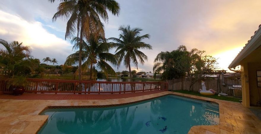 Lakefront pool home w/ BONUS 5th room.  Boasting over 3,100 SQ FT under air, this waterfront pool home is nestled in sought-after Jacaranda Lakes. Split floor plan offers private, generous master suite with pool/patio access & master bath for his/hers.  BONUS office/den/bedroom w/ private entrance. Three spacious bedrooms w/ updated laminate flooring (2021) & remodeled bathroom (2020).  Lg family room w/ soaring ceilings, dry-bar, formal living room & open-concept kitchen w/ SS appliances & granite. Screened front door & 24x24 porcelain tile.  Fenced-in yard w/ sparkling, upgraded salt-system pool; wood deck, travertine deck/patio, large lanai(s) & pool safety net.  New AC & hot water heater (2022).  You're safe w/ shutters & impact garage door.