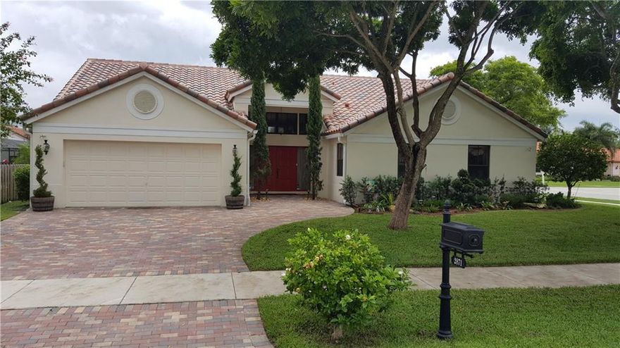 Lovely home on a corner lot located in the sought after community of Forest Ridge in Davie.  This home has volume ceilings and wood floors throughout the living areas.  The home sits on a large corner lot in the Estate Section, heated pool and spa with a large deck with safety screening around the pool, plenty of yard with lots of grass for your enjoyment.  Open spacious kitchen with granite counters and stainless appliances.  The roof is less than 1 year old.    Come and enjoy the Ridge Nature Area.