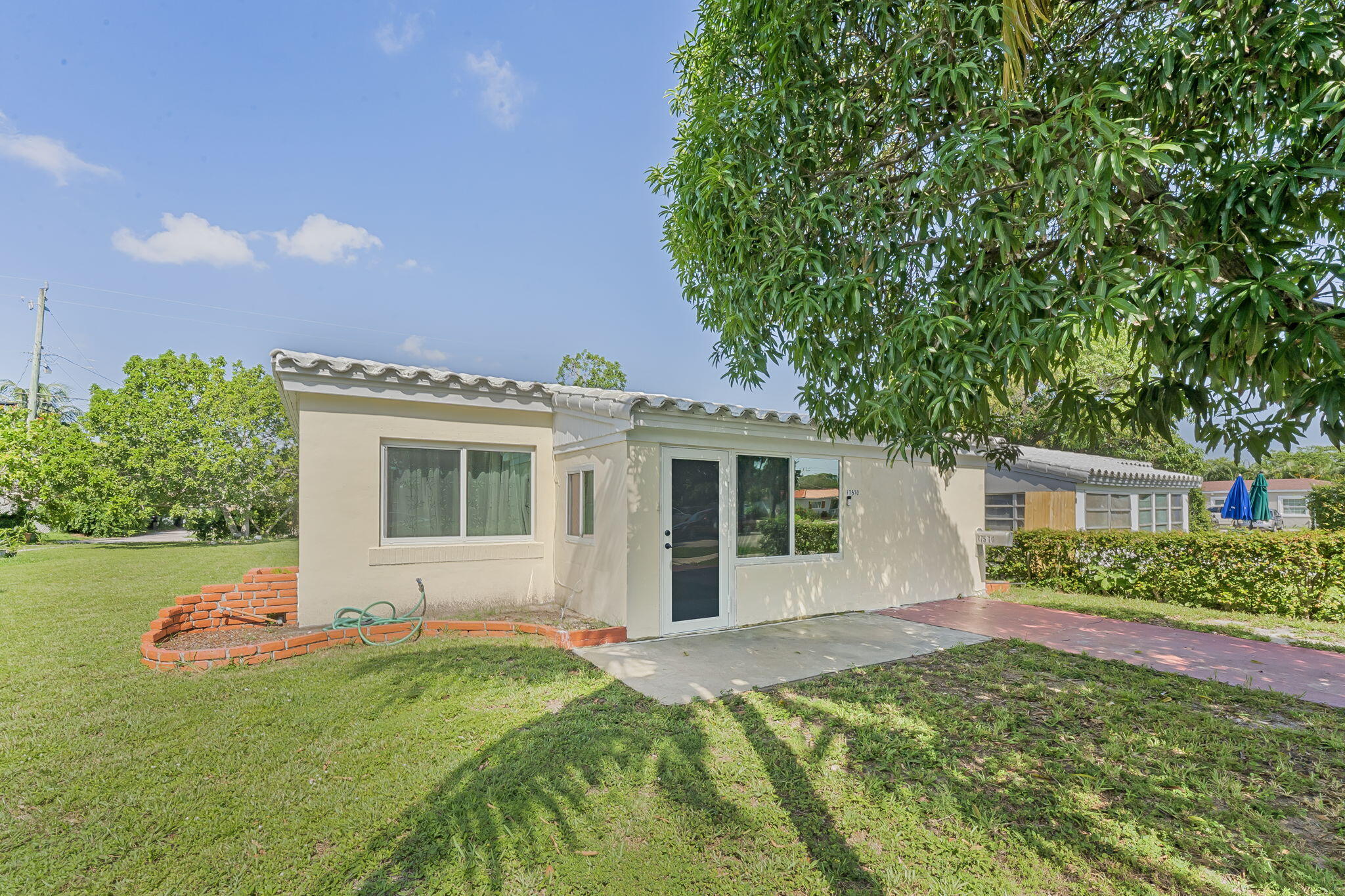 Welcome to this charming 3 bed, 1 bath single family home. Features include newly installed IMPACT windows for peace of mind. Top to bottom renovated bathroom, Tile floors throughout and a tankless water heater. Lots of storage provided with walk in closets, outside shed, & inside large enclosed storage room, plus bonus entry room. Enjoy the added convenience of an inside laundry room and spacious backyard with mango, avocado, plum, cashew and coconut trees. Ideally located close to shopping, dining, major highways and the beach. This home combines comfort, convenience, and value in one great package. This home qualifies for a grant with PNC bank up to 10k plus 1% of the purchase price that can be used towards closing costs, rate buy down, etc.