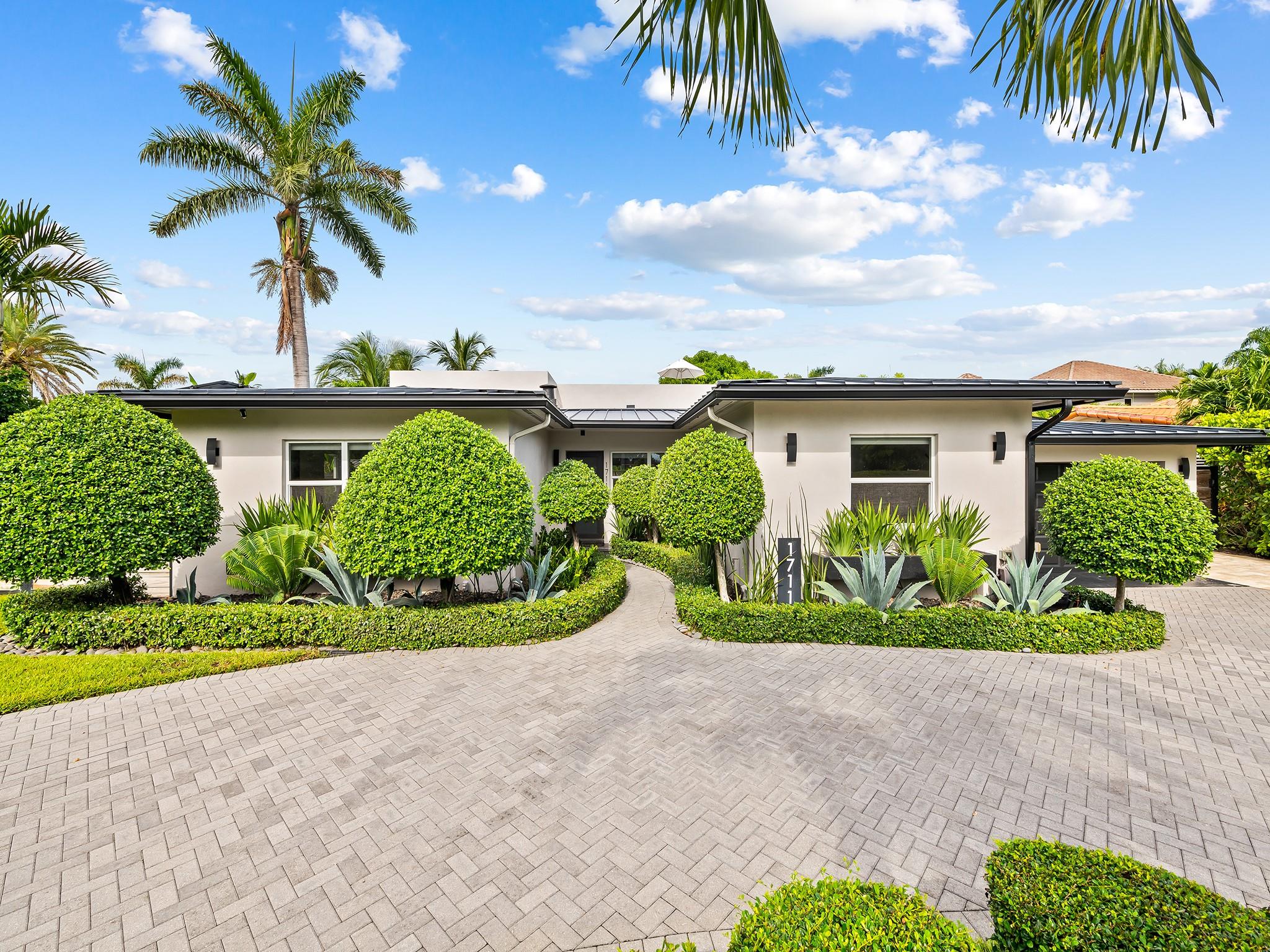 Magnificently reimagined, this home combines modern sophistication with timeless luxury, with the feel of brand-new construction. Sun-drenched interiors flow through an open-concept design, glass stacking doors dissolve the boundary between indoor and outdoor living. Entertain beneath the covered terrace with its louvered electric ceiling, swim in the sparkling saltwater pool—heated or chilled for year-round enjoyment—or retreat to the rooftop terrace for panoramic views of waterfront yachts. The chef’s kitchen is beautifully appointed with top-tier appliances while the serene primary suite offers dual custom closets and tranquil bath. Thoughtful enhancements, including a mosquito misting system, water filtration, and solar panels, elevate everyday living with effortless elegance.