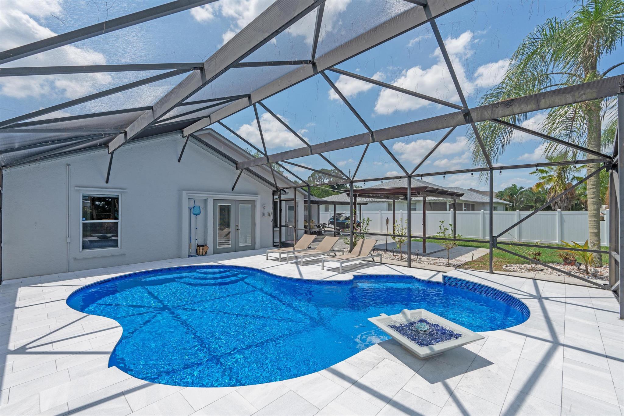 Completely Renovated 4-Bedroom Canal Home with Stunning Pool & Smart FeaturesThis beautifully updated 4-bedroom, 2-bathroom home sits on a peaceful canal and offers the perfect blend of luxury, comfort, and technology. Every detail has been thoughtfully upgraded--from the inside out.Exterior Highlights:New roof and gutters (2024)Fully remodeled pool (2024) with Diamond Brite Azure finish, new Grey Pearl marble deck with Infinity coping, color-changing MicroBrite lighting, and a stunning new water fountain bowlNew pool heater, pump, and IntelliChlor salt system, all controllable via smart appTwo spacious driveways--ideal for extra vehicles, RV, or boat parkingInterior Features: