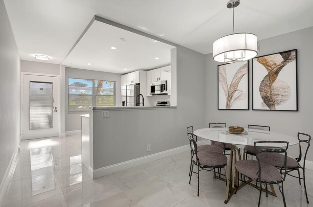 FULLY RENOVATED 2-Bedroom Condo in the Heart of Wynmoor! This beautifully UPDATED 2-bed, 2-bath condo is located in the desirable Lucaya Village within the 55+ Wynmoor community. This spacious 2nd-floor unit features an open floor plan with plenty of natural light, LAKE VIEWS, an updated kitchen with modern appliances & ample cabinet space. Primary suite with a walk-in closet & en-suite bath. The unit is tiled throughout, offering easy maintenance & a fresh, clean look. Wynmoor is renowned for its resort-style amenities, including a championship golf course, fitness center, tennis courts, pools, theater, restaurant, numerous clubs & social activities. 24-hour gated security with access to shopping, dining, & major highways, this is South Florida active adult living at its best.