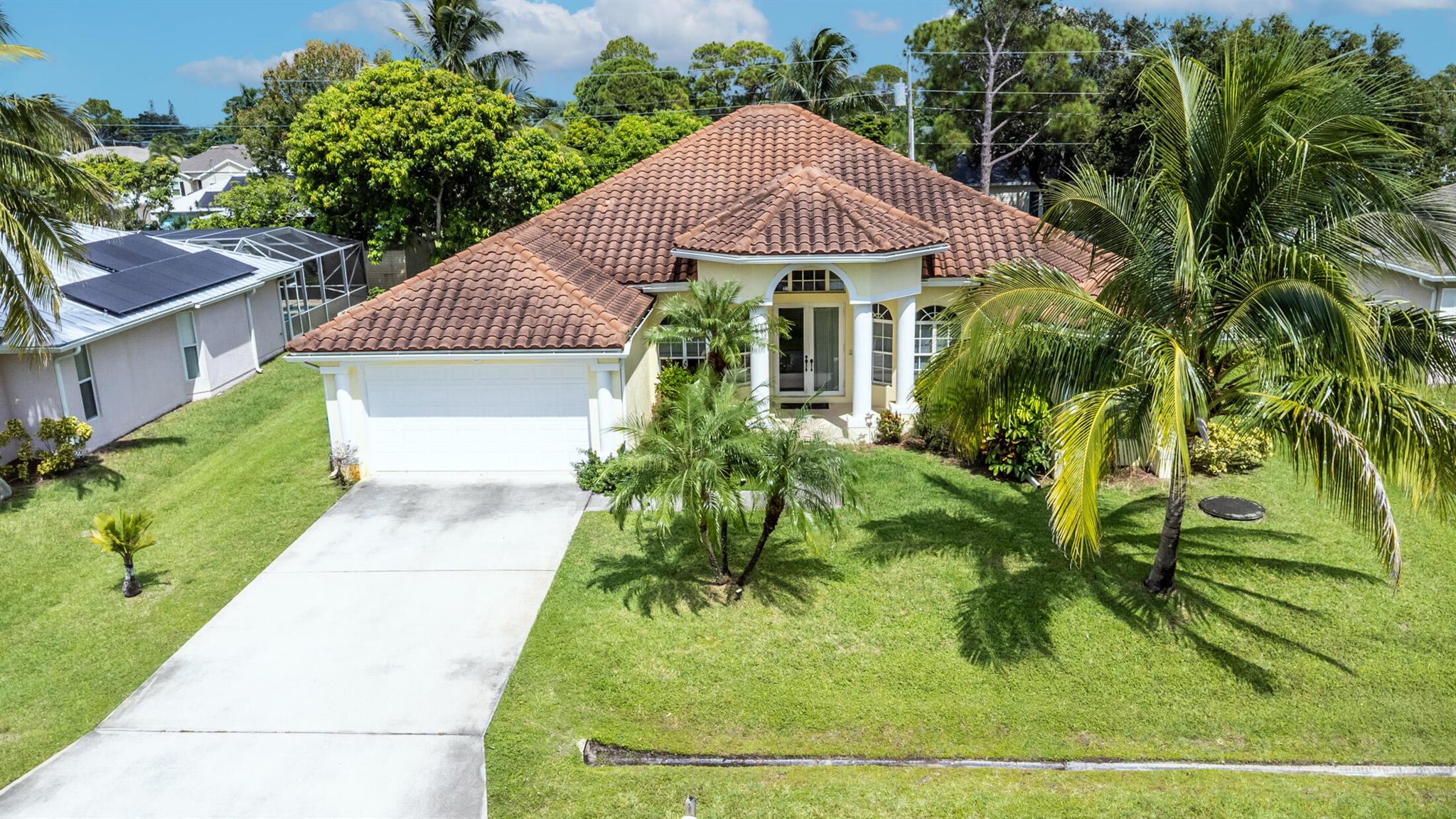 Nestled in the desirable east area of Port St. Lucie, this beautiful custom home with a Mediterranean Style flair offers the perfect blend of elegance, space, style and comfort. Home Features: 4 BR,3 Full baths, a den/office, formal dining, living and family room, Impact windows and doors and resort style pool. As you step inside, you'll be welcomed by an open concept layout, tile flooring throughout and custom triple tray/ volume ceiling, creating a seamless and modern feel from room to room. Kitchen has granite countertops,Built-in Island,SS appliances, Gas Stove and custom cabinetry. Master bedroom includes his and hers closets,open Walk-In shower and a separate jacuzzi tub. Home is closer to Jensen Beach/Martin County, minutes away to beaches,shopping,restaurants,hospital and schools.