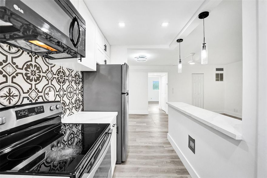 Modern coastal living East of US-1! This beautifully refreshed 1BR/1.5BA residence at Santa Monica Condo features sleek vinyl flooring, clean lines, and soft neutral tones. The designer kitchen boasts stone countertops, stainless steel appliances, white cabinetry, a custom tile backsplash, and a breakfast bar. The spacious primary bedroom offers generous closet space, while both bathrooms feature contemporary finishes and modern vanities. Enjoy a screened patio perfect for sunset views. This pet-friendly building offers a community pool, sauna, assigned parking, and storage. Ideally located minutes from Hollywood Beach, the Broadwalk, nature preserves, dining, and FLL Airport. Hurricane impact windows and doors provide peace of mind. Ideal as a primary residence or a coastal retreat.