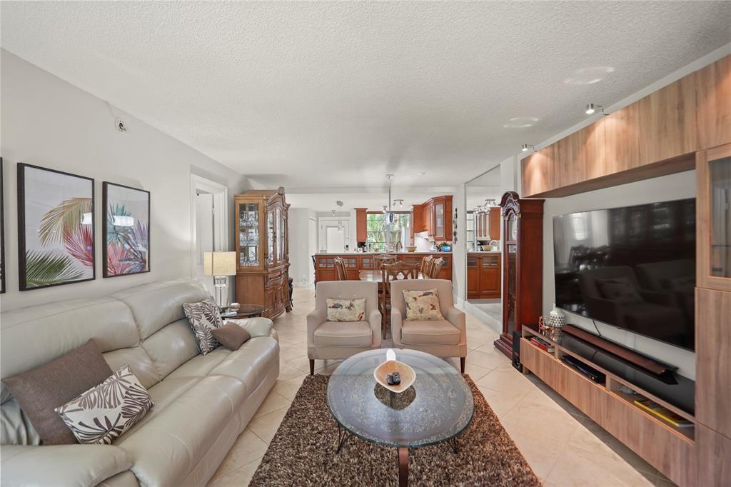 Step into luxury in this exquisite renovated condo that comes fully furnished and has a beautiful open kitchen with abundant counter space perfect for the ulinary enthusiast. The updated bathrooms exude elegance and style. Revel in the beauty of ceramic tile flooring throughout adding a style of sophistication to the space. Unwind on the enclosed balcony while enjoying a beautiful pool view. This meticulously designed unit offers a blend of comfort and functionality, creating the perfect oasis to call home.