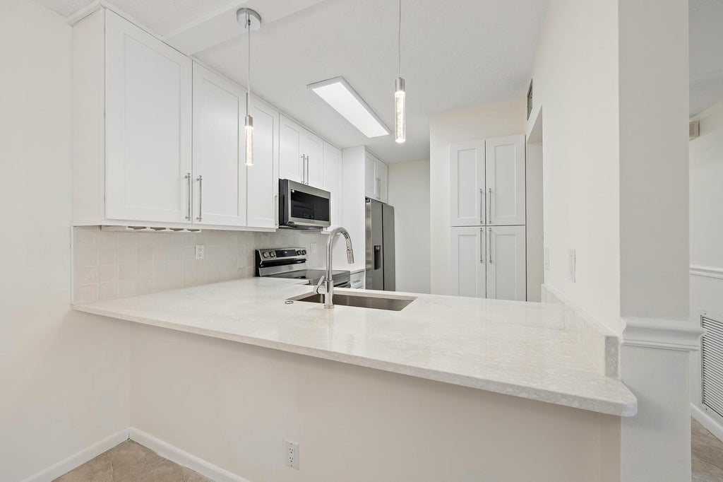 Photo of 3404 GARDENS EAST Drive #21A, Palm Beach Gardens, FL 33410 (MLS # B26075611)