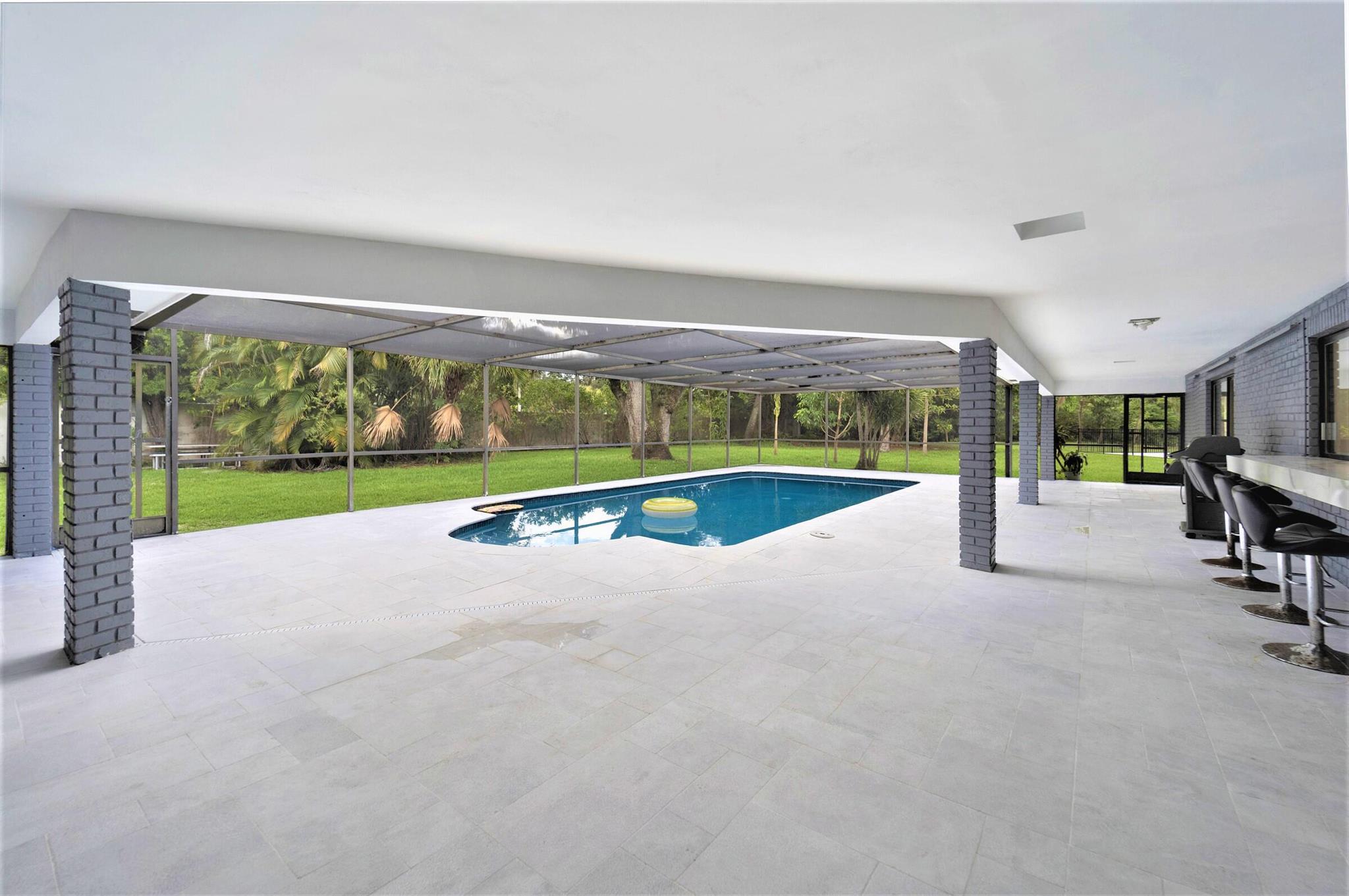 Unique opportunity to own a beautifully renovated single-story home on over 1/2 ACRE in the highly sought-after, low-HOA community of Estancia. This spacious 4-BEDROOM, 3-BATH residence features a functional split-bedroom floor plan, ideal for comfort and privacy. Each bedroom offers generous space and built-out closets, with a completely updated interior showcasing modern finishes throughout.Tranquil backyard oasis with a gorgeous pool area surrounded by GREAT PRIVATE YARD. Located within a 24-hour guard-gated community, Estancia is centrally positioned close to top-rated public and private schools, houses of worship, shopping, and dining.Experience South Florida living at its finest in this move-in-ready gem. all measurements are approximate and should not be relied upon
