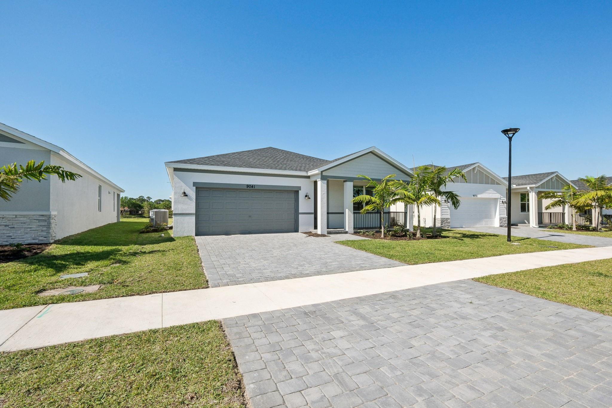 Beautiful canal views and peaceful natural setting. This brand new 4-bedroom, 3-bathroom home features a spacious 2-car garage, sturdy impact-resistant windows and doors, screened-in patio, elegant tile flooring throughout the social areas, and cozy carpeting in each bedroom. The open-concept design offers a warm, connected space where the kitchen flows effortlessly into the living and dining areas — ideal for entertaining guests or spending relaxed time with family. Perfectly positioned, this home provides quick access to key commuter routes and is minutes from St. Lucie West Town Center, Mets Spring Training, world-class golf courses, excellent restaurants, stores and lively entertainment venues.