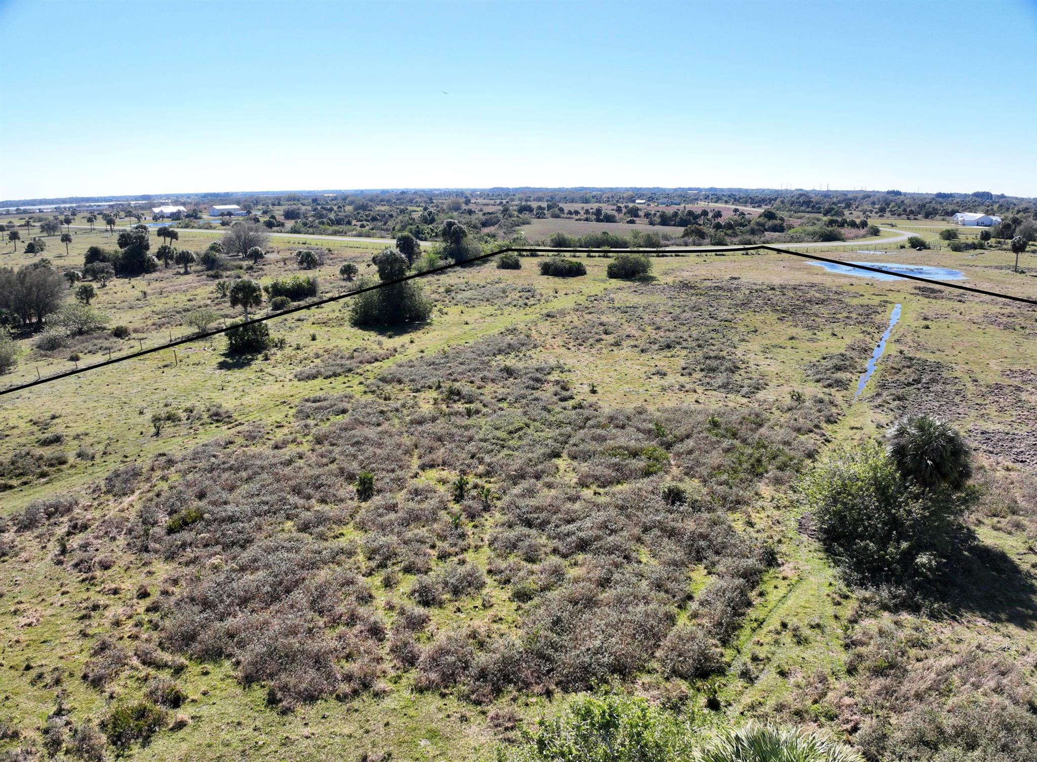 Lot 20. Build your dream home in an emerging residential community! Two adjacent lots totaling 26.64 acres. Lots 20 and 31 can be purchased together for a reduced price or separately as listed. In a beautiful, gated community designed for rural estate living. 2,000 sq ft minimum build under air, with the option to add a guest house up to 50% of the primary residence's size. Embrace Country living with amenities like barns and stables, plus over 5 miles of bridle paths for horse riding, cattle raising, and gardening. Just a 10 min drive from town and near Lake Okeechobee.
