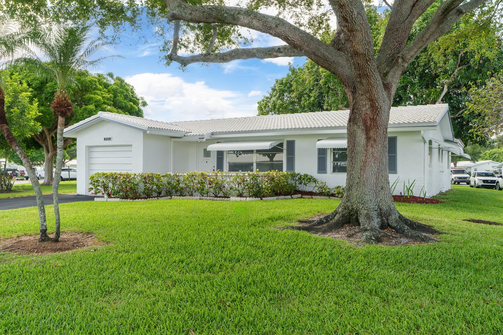 Lauderdale West, 55+ Community, 2/2 W/Garage, NEW TILE ROOF 2022. LOWEST PRICE SFH IN THE COMMUNITY. Walk to main clubhouse. Double wide driveway. Low maintenance includes Cable TV & Wi-Fi, repair/replace tile roof, 2 heated pools, 2 spas, saunas, 3 Tennis courts, fully equipped fitness center, billiards, ping pong, private library, professional shows, clubs, community bus at your doorstep to shopping and more. Near to shopping, restaurants etc. Home perfect candidate for updating to your style. 20% down required per HOA and good credit. ESA & Service animals welcome.