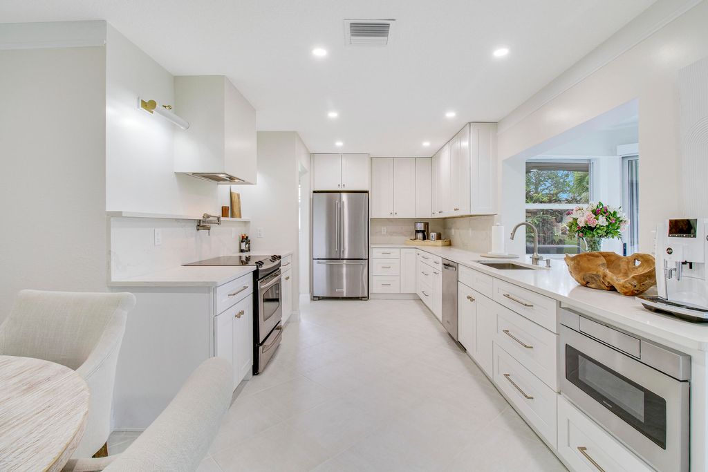 Photo of 125 Clubhouse Boulevard, Atlantis, FL 33462 (MLS # R10988226)