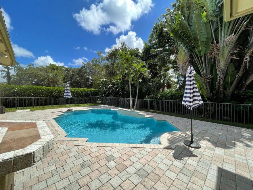 TROPICAL OUTDOOR LIVING at its finest! Enjoy total privacy with mature landscaping surrounding your oversized newly resurfaced freeform pool. The summer kitchen is great for entertaining while enjoying ''alfresco dining'' in your screened-in patio. The lushly landscaped yard backs to the 12th fairway of the Wellington National Golf Club. This fully fenced-in yard has plenty of greenspace for our 4- legged friends to roam as well. The prestigious gated community of Binks Estates known for its oversized homesites, and mature landscaping is just minutes from the A-rated schools. As you enter you are immediately drawn in with the abundance of glass, & high-volume ceilings bringing the outdoors in. This open concept home will be freshly painted prior to new tenant moving in. Plenty of space with both a living room and family room. Family room has a large entertainment center to enjoy as well. Kitchen has stainless appliances including a double oven and newer French door refrigerator. 

Spacious home features 4 bedrooms plus a den which is perfect for using as an in-home office for working remote. Master suite is quite large with laminate floors and a French door to enjoy easy access for a morning swim. Master bath is well appointed with wood cabinetry, vessel sinks, marble floors and shower. Relax after a long day in your 6-jet spa shower or jacuzzi tub. This beautiful home offers beautiful streetscape with new roof and painted exterior. This one will not last long...current tenant moves out August 20. Close to Southern Blvd. for easy commuting, hospitals, A-rated schools and all equestrian venues.