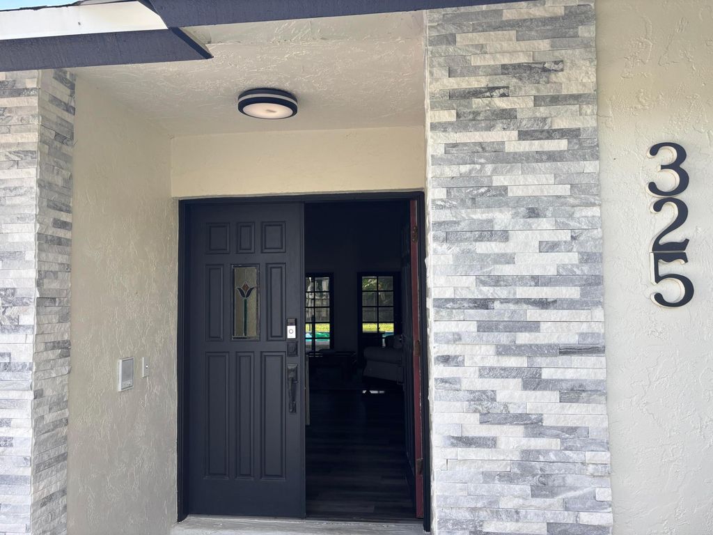 Photo of 325 Knotty Wood Lane, Wellington, FL 33414 (MLS # R11159584)