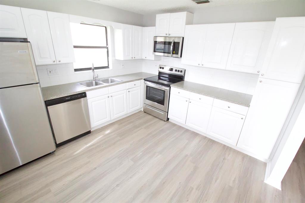 Quiet & Completely Renovated HUGE villa with 2 bedrooms & 2 beautifully renovated bathrooms. Brand new kitchen with white shaker custom cabinetry, plank flooring, brand new appliances, new bathrooms with custom vanities, new fixtures, all freshly painted thru out. PRIVATE BACKYARD AREA to spread out and enjoy south Florida living at its best. he biggest unit available for the price. Come today! Located near Northlake Blvd, close to beaches, shopping, restaurants, easy access to 95, only 10 minutes north of downtown West Palm Beach. PRIVATE BACKYARD FENCE IN PROCESS OF INSTALLATION ! $40/month pest control & common area maintenance fee additional.