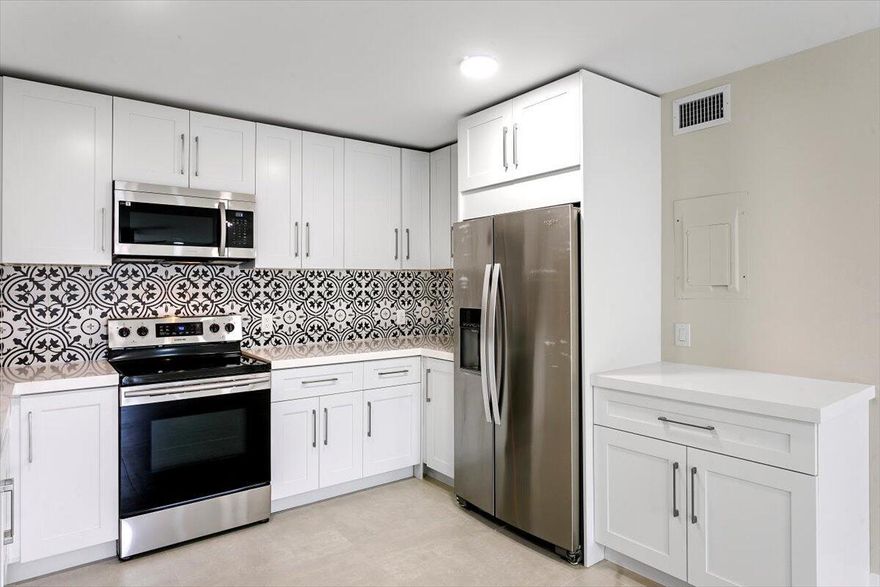 Come see this rare 2BR + DEN, 2BA FIRST FLOOR end unit that is fully renovated with modern finishes throughout.   Located in the highly desirable all-age community of Waterside Village.  Features 32x32 Porcelain tile flooring, a redesigned kitchen with quartz countertops, shaker cabinetry, designer backsplash, and stainless-steel appliances, along with a laundry room equipped with a full-size washer and dryer.  Additional features include Accordion Shutters, Water Heater 2017, A/C 2019, and storage closet across the entrance.  This move-in ready condo offers the opportunity to enjoy a comfortable and active lifestyle in a prime location.Waterside Village provides exceptional community amenities including two heated pools, spa and hot tub, tennis courts, shuffleboard, basketball, bocce,