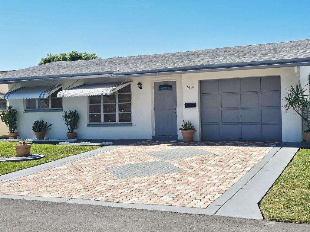 Photo of 5713 NW 65th Te Ter, Tamarac, FL 33321 (MLS # F10547953)