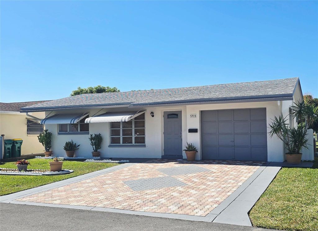 Photo of 5713 NW 65th Te Ter, Tamarac, FL 33321 (MLS # F10547953)