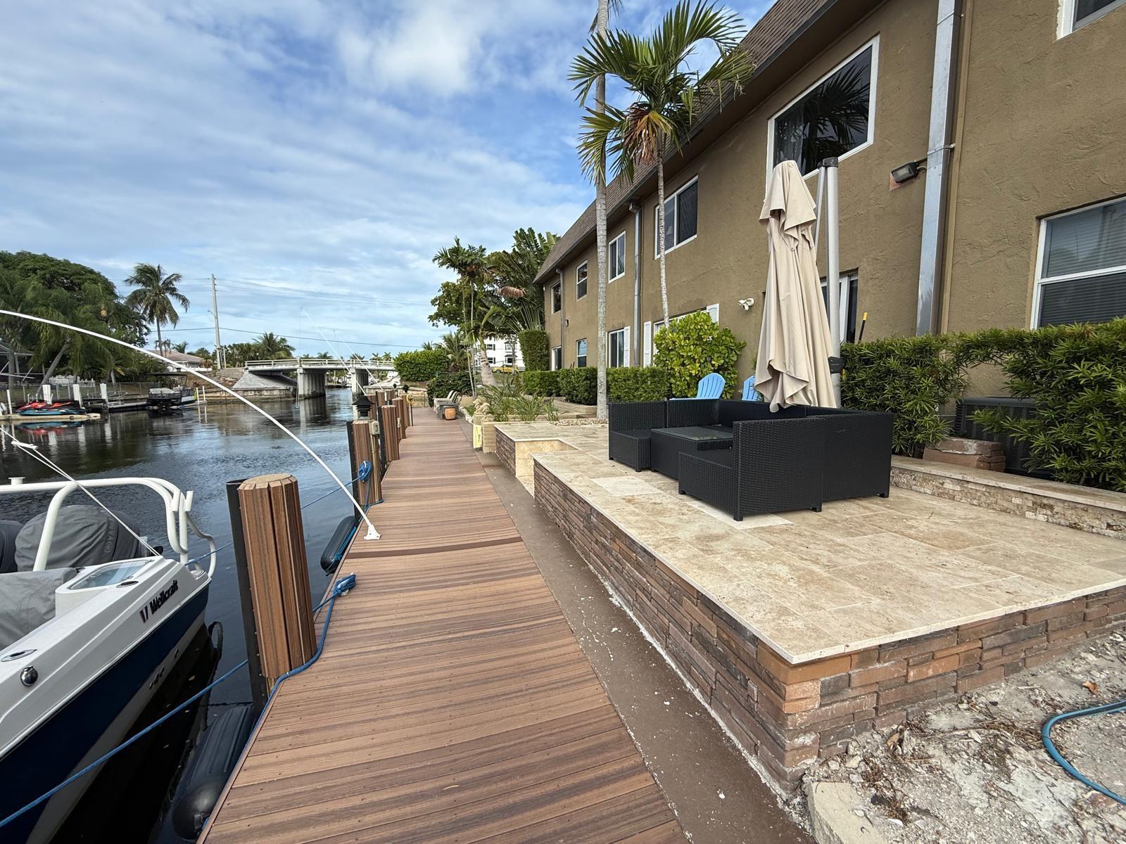 Modern 2-bedroom, 2-bathroom first-floor condo located directly on the water, featuring a 30-foot dock with water and electric connections. Positioned east of US-1 in a desirable area within walking distance to the beach, shops, restaurants, and other conveniences. The building is situated on a wide canal with direct ocean access. The unit offers contemporary finishes, impact-resistant windows and doors, and a private backyard area. 680+ Fico